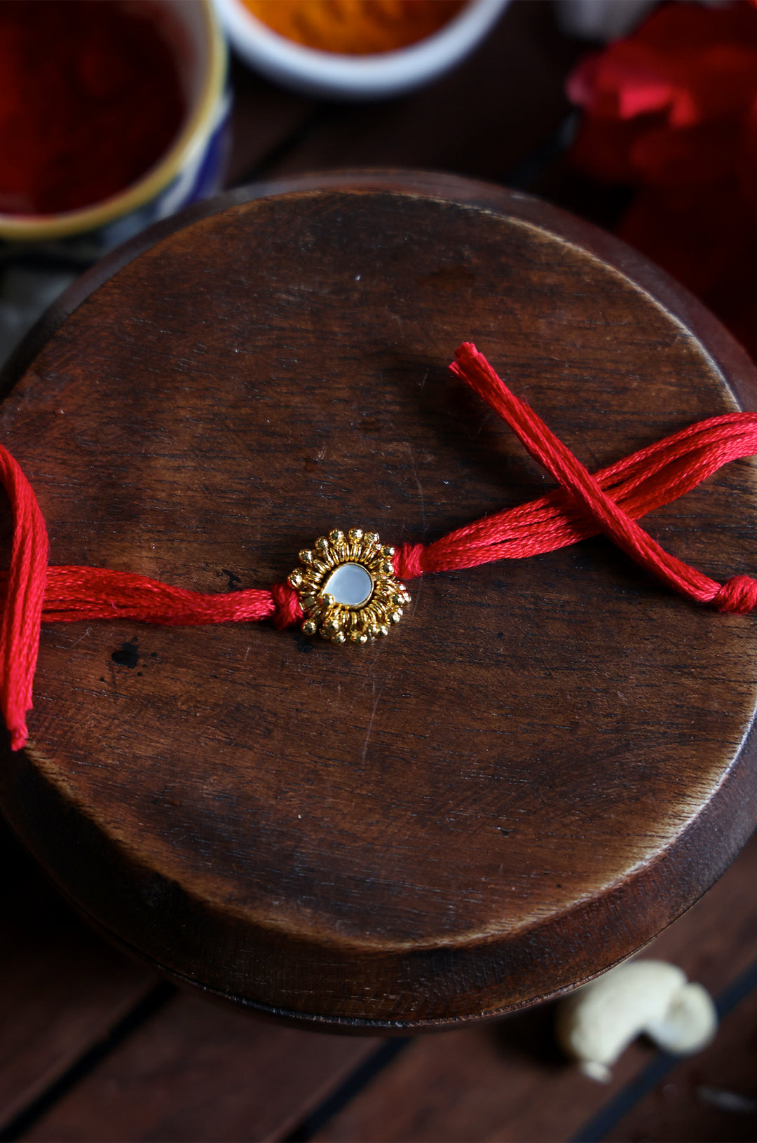 Drishyam Red Gold Plated Pearl Rakhi